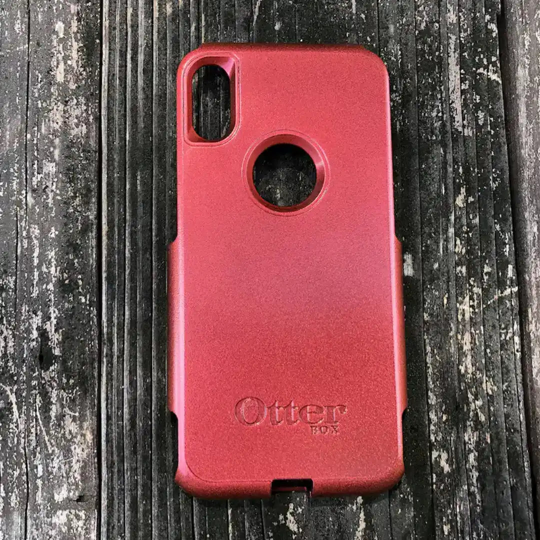 A red OtterBox phone case.