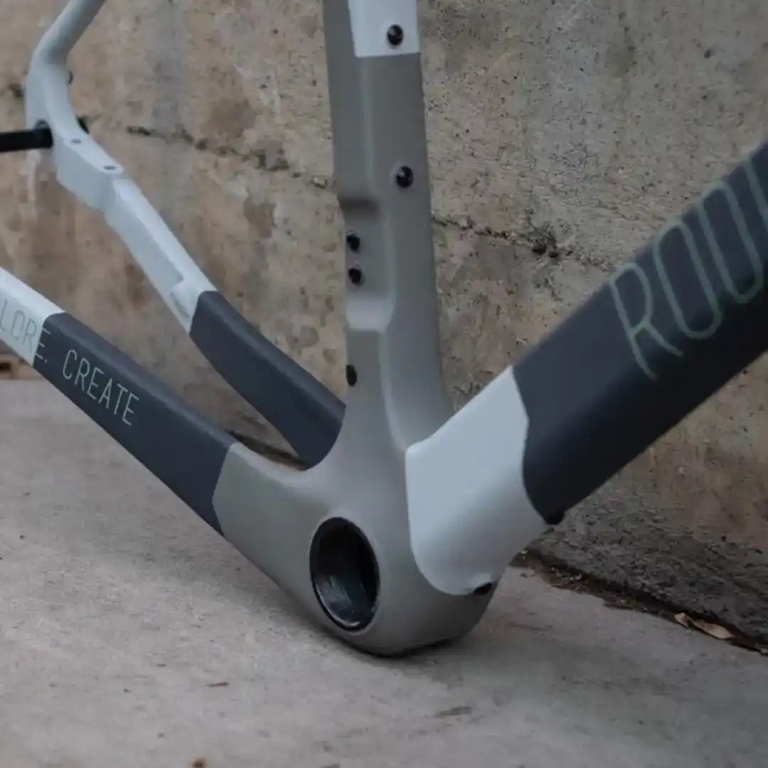 A gray and white bicycle frame with a visible bottom bracket shell.