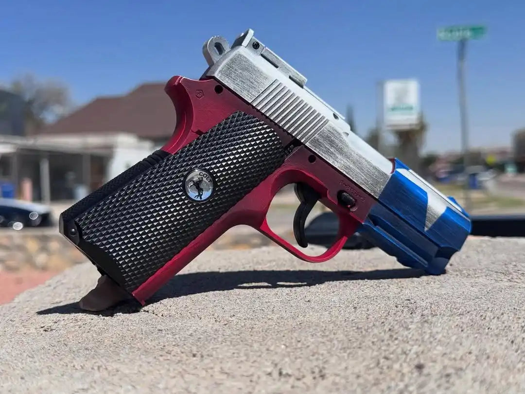 Red and blue pistol with silver accents, likely a kimber model.